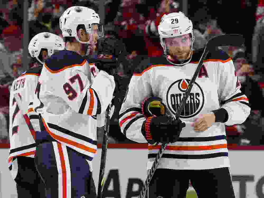 Connor McDavid (97) and Leon Draisaitl (29) of the Edmonton Oilers talk during a video review in the third period against the New Jersey Devils at Prudential Center on December 31, 2021 in Newark, New Jersey.