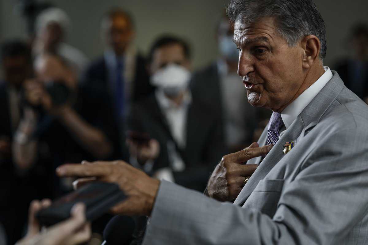 Senator Manchin gesticulates while speaking.