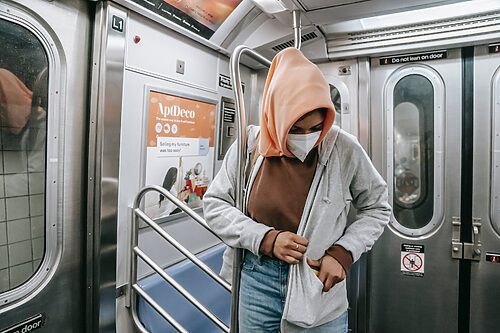 woman in mask in underground train